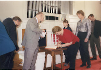 Signing the Membership Book